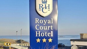 A sign for the Royal Court Hotel with a coastal view. - The Royal Court Hotel (Portrush)