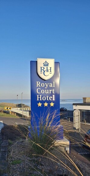 A sign for the Royal Court Hotel with a coastal view. - The Royal Court Hotel (Portrush)