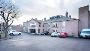 A street view with a hotel named "Bridge Hotel" and several parked cars. - Palace Hotel (Peterhead)