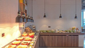 A modern kitchen with a long counter displaying various food items and utensils. - Holiday Inn Sunderland, an IHG Hotel (Sunderland)