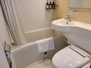 A bathroom with a bathtub, a toilet, and a sink. There are three bottles on a shelf above the sink. - Ai Hotel Hashimoto (Sagamihara)