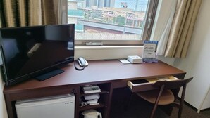 A hotel room with a TV, a phone, a coffee maker, and a view of the city through the window. - Ai Hotel Hashimoto (Sagamihara)