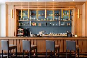 A bar area with wooden shelves, hanging lights, and bar stools. - Holiday Inn Sepang Airport (Sepang)