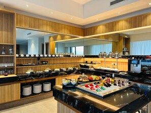 Una cocina moderna con encimera de mármol, armarios de madera y un espejo grande.