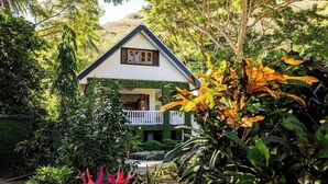 A house with a white exterior, dark roof, and a balcony with white railings. - Waya Island Resort (Yasawa Island)