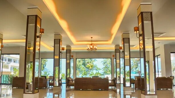 A spacious lobby with a modern chandelier, large windows, and a central seating area. - Seapine Beach Golf and Resort Hua Hin (Hua Hin)