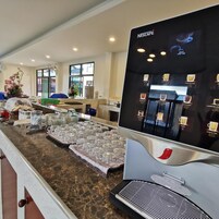 A Nescafe coffee station with a selection of beverages and a buffet area with food items.