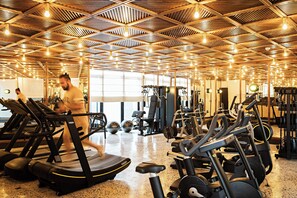 A gym with treadmills, exercise balls, and weight machines. - La Maison Palmier (Abidjan)
