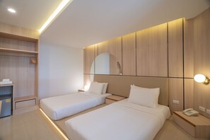 A modern hotel room with two beds, a walk-in closet, and a bedside telephone. - Bedline Hotel - SHA Certified (Phuket)