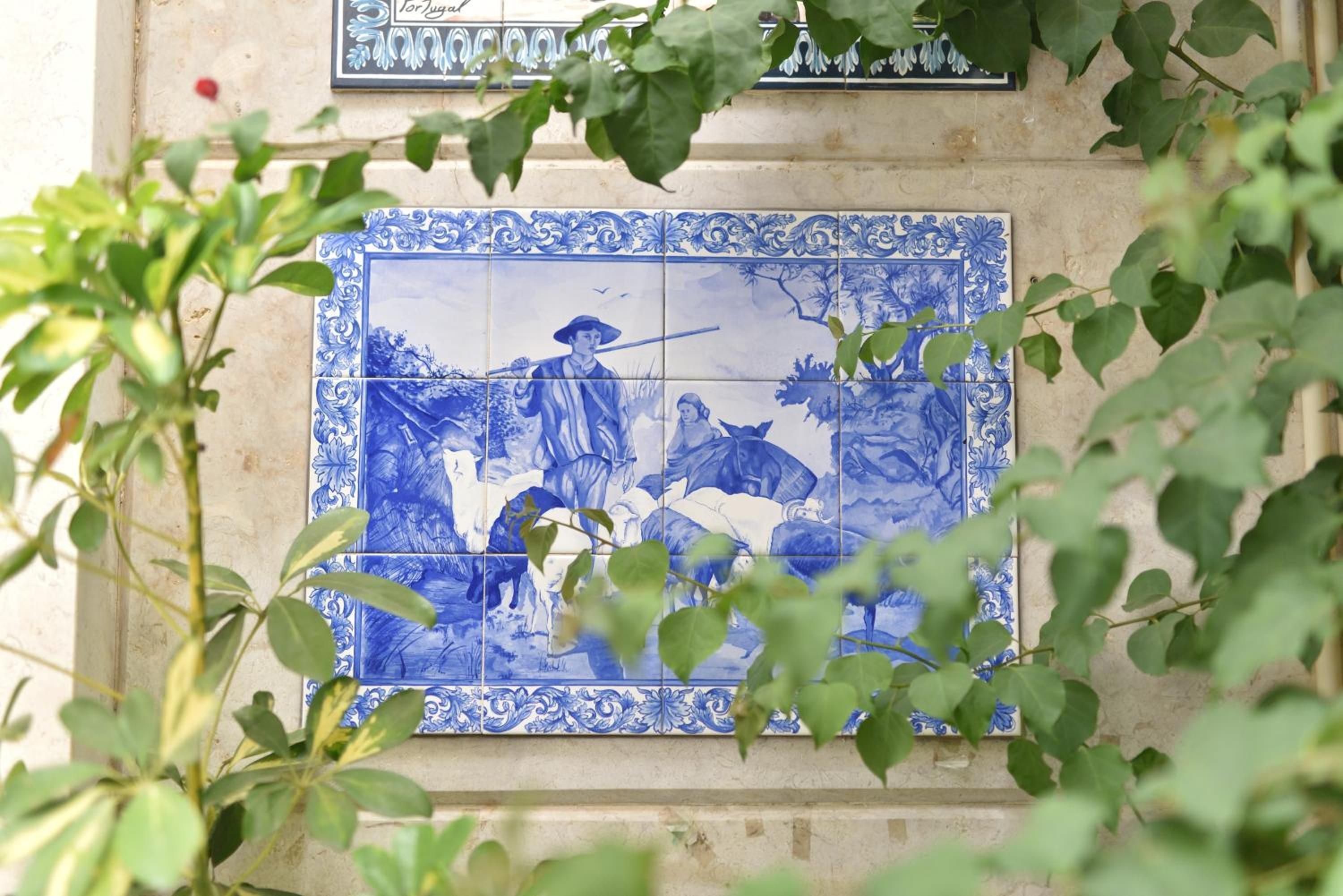 A blue and white tiled wall with a traditional design.