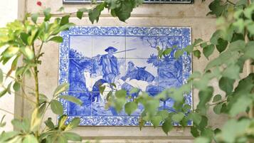 A blue and white tiled wall with a traditional design.