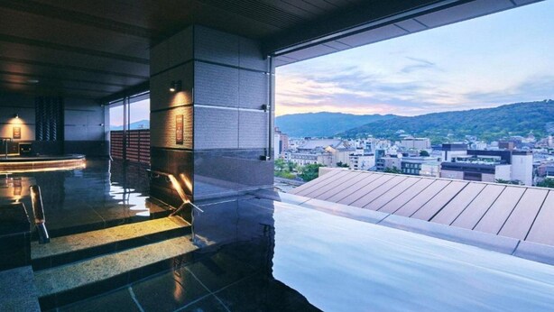A modern hotel room with a large window overlooking a cityscape and mountains. - Shijo Kawaramachi Onsen Soraniwa Terrace Kyoto (Kyoto)