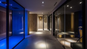 A modern hotel corridor with glass walls, recessed lighting, and a wooden accent wall. - Ethereal White Resort Hotel & Spa Adults Only 16+ (Heraklion)