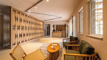 A modern interior with a wooden wall panel, a round coffee table, and seating area.