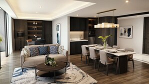 A modern living room with a sofa, coffee table, and dining area with chairs and a table.
