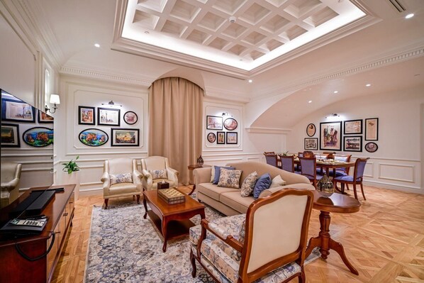 A spacious living room with a high ceiling, a dining area, and a large window. - 21 High Street Residence (Doha)