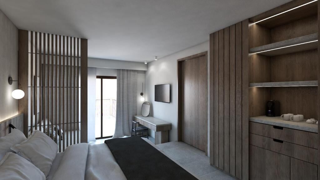 Una habitación de hotel moderna con cama, escritorio y armario empotrado.