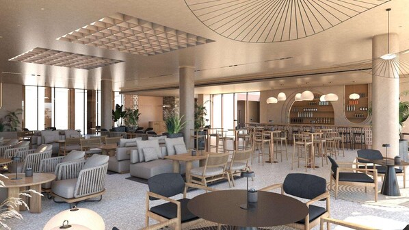 Un hall d’entrée spacieux, doté d’espaces de détente, d’un bar et de grandes fenêtres.