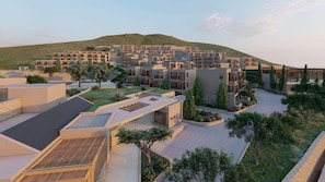 A modern residential complex with multiple buildings, rooftop gardens, and a hilly backdrop. - Elios Hill (Hersonissos)