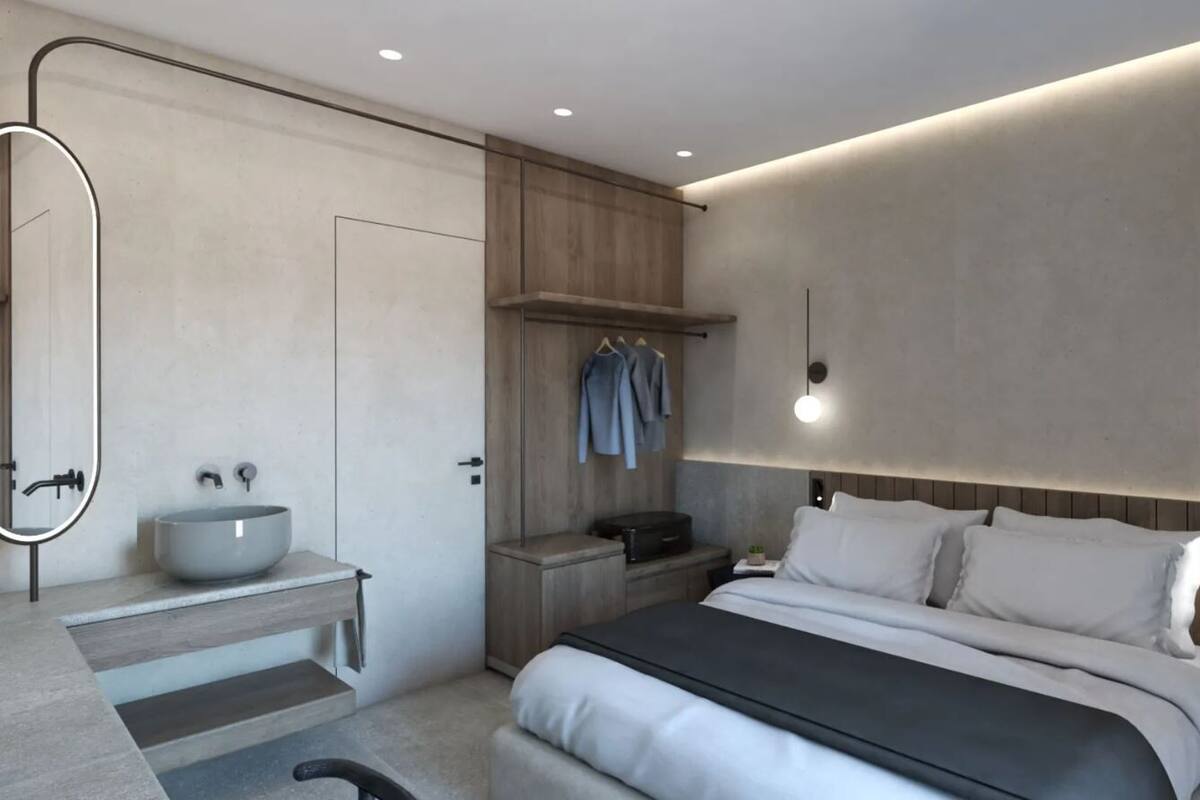 A modern bedroom with a large bed, bedside tables, a built-in bench, a wall-mounted vanity, and a large mirror.