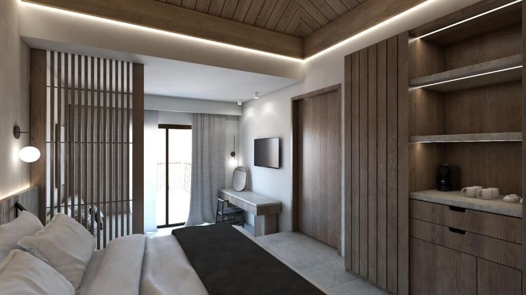 Una habitación de hotel moderna con cama, escritorio y armario.