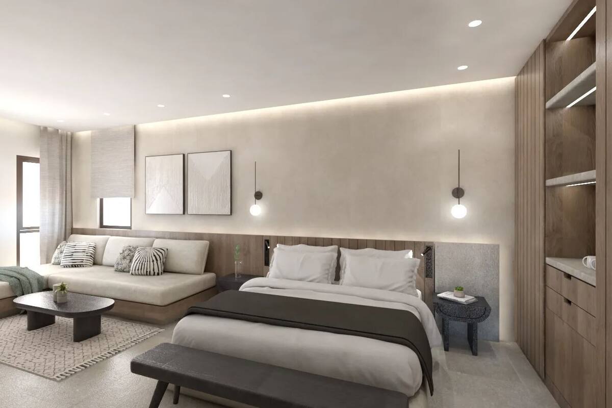A modern bedroom with a bed, bedside tables, a sofa, and a coffee table.