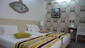 A hotel room with two beds, a desk, and a chair. - Paredes Design Hotel (Paredes)