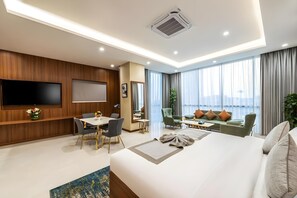 A modern hotel room with a large bed, a flat-screen TV, a dining area, and a balcony with a view. - Sunday Luxury Central Formerly Anan Hotel (Riyadh)