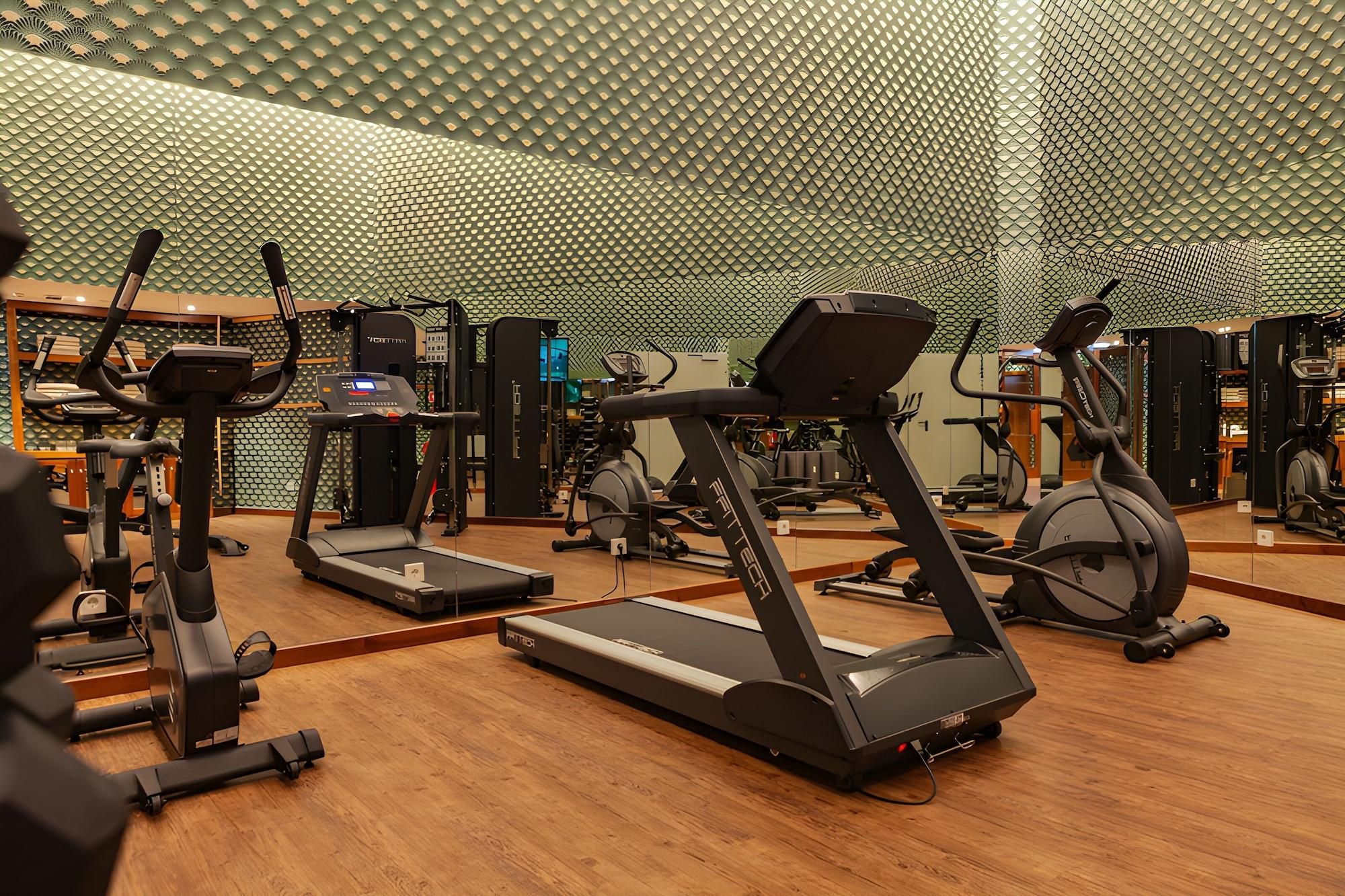 A gym with treadmills, ellipticals, and weight machines.