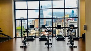 A gym with treadmills and stationary bikes, large windows with a city view. - Chambers Kuala Lumpur by Five Senses (Kuala Lumpur)