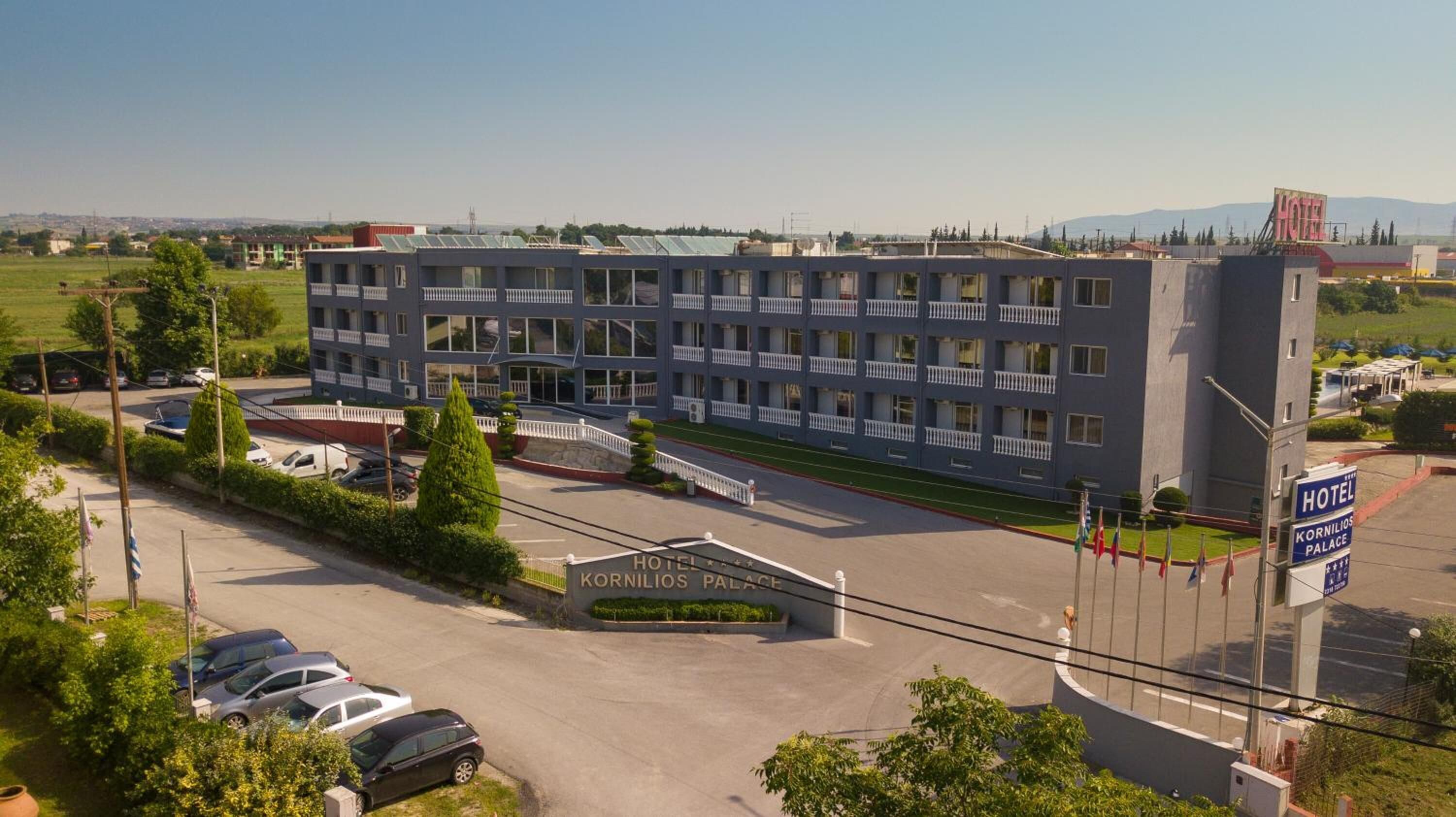 A hotel with a modern design, featuring multiple balconies and a central courtyard.