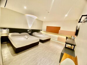 A hotel room with two beds, a desk, and a small table. - Woco Hotel Kinrara (Puchong)