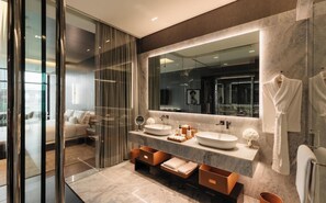 A modern bathroom with two sinks, a large mirror, and a glass shower enclosure. - Hotel Alexander (Mexico City)