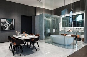 A modern bathroom with a glass-enclosed shower, a large bathtub, and a vanity with a mirror. - Hotel Alexander (Mexico City)