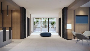 A modern lobby with a central seating area, large windows, and a minimalist design. - B21 Hotel (Bari)