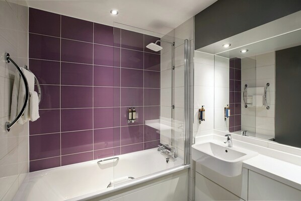 A modern bathroom with a glass-enclosed shower, two sinks, and a large mirror. - Premier Inn Cambridge City Centre (Cambridge)