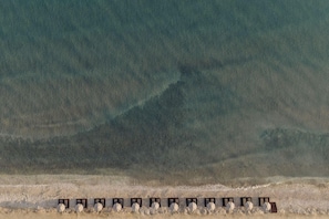 A row of hexagonal structures in a desert landscape. - Unda (Corfu)
