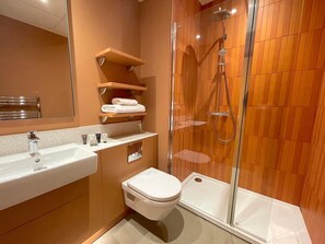 A modern bathroom with a glass-enclosed shower, a white sink, and a toilet. - Hex Wildlife Hotel At Yorkshire Wildlife Park (Doncaster)