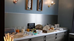 A breakfast buffet setup with various food items and beverages. - Hotel De Normandie (Gournay-en-Bray)