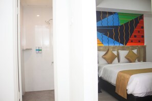 A hotel room with a bed, a shower, and a colorful abstract painting on the wall. - Urban Hotel Serpong by Zuzu (South Tangerang)