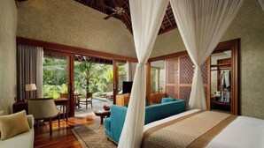 A spacious bedroom with a large bed, a sofa, a desk, and a view of the outdoors. - Abisena Wellness & Resort Ubud-adult Only (Tegallalang)