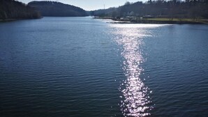 A calm lake with a clear reflection of the sky and distant hills. - Hotel Radevormwald (Radevormwald)