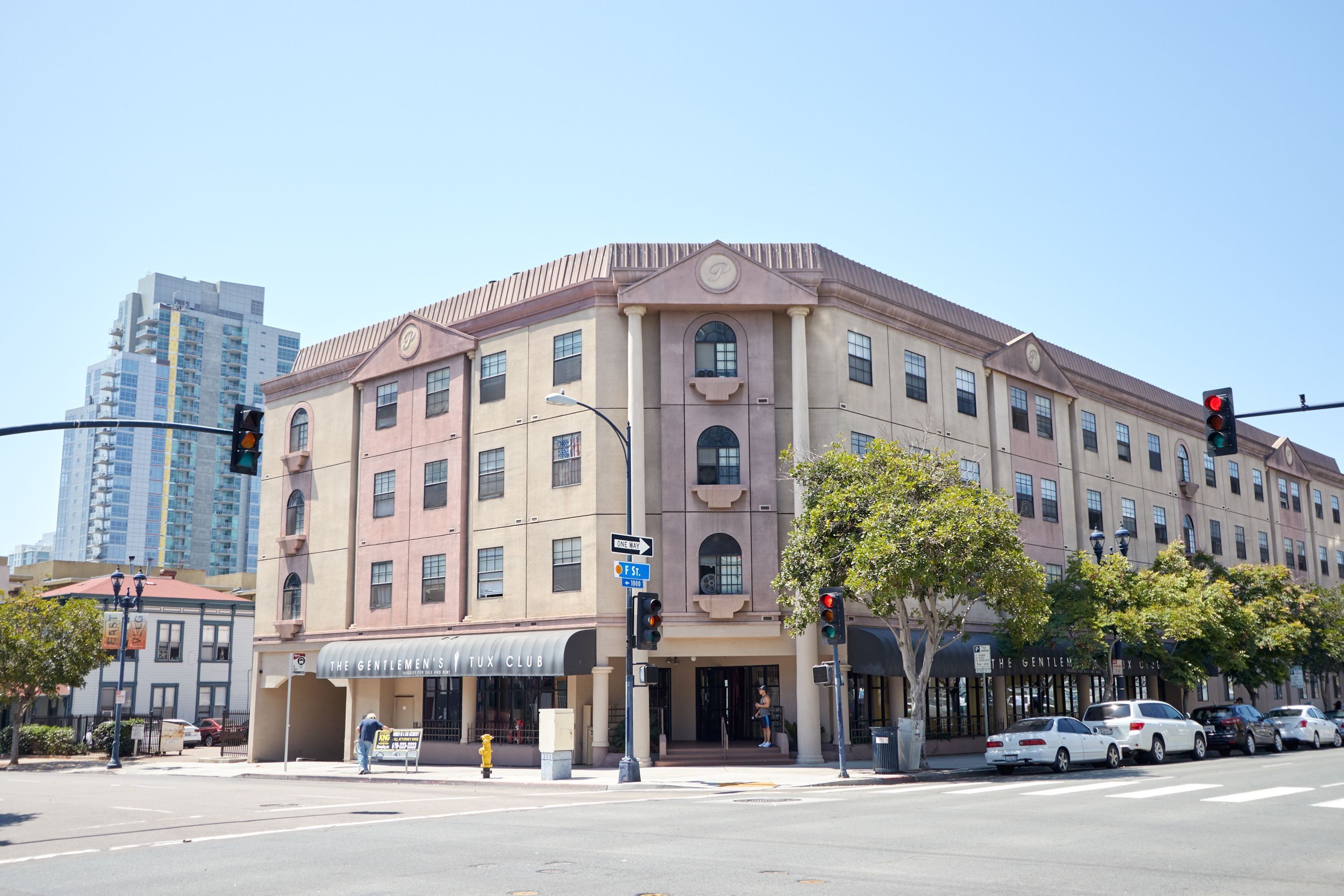 A multi-story building with a classic architectural style, featuring a prominent entrance with a marquee sign.