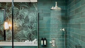 A bathroom with a shower, a mirror, and a wall with a tropical leaf pattern. - The House Hotel Galway (Galway)