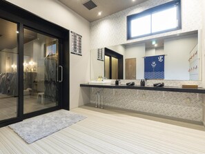 A modern bathroom with a glass door entrance, a large mirror, and a towel rack. - Kyoto Plaza Hotel Kintetsu Jujo (Kyoto)