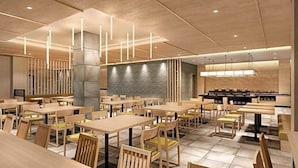 A modern restaurant with wooden tables and chairs, a stone wall, and pendant lighting. - Kyoto Plaza Hotel Kintetsu Jujo (Kyoto)