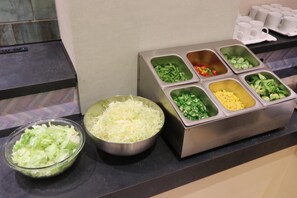 A buffet area with various food options including shredded vegetables, green beans, bell peppers, broccoli, corn, and a bowl of lettuce. - Kyoto Plaza Hotel Kintetsu Jujo (Kyoto)