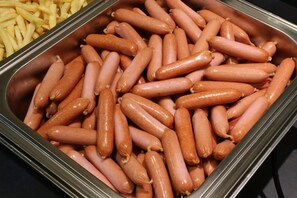 A tray of uncooked sausages and a container of french fries. - Kyoto Plaza Hotel Kintetsu Jujo (Kyoto)