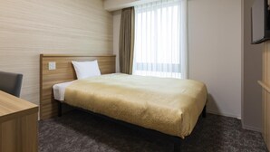A hotel room with a bed, a desk, a chair, a television, and a window with curtains. - Kyoto Plaza Hotel Kintetsu Jujo (Kyoto)