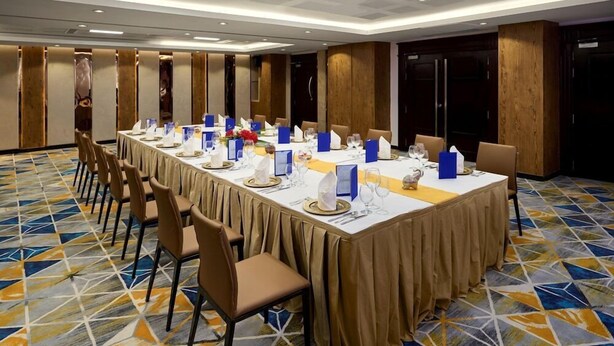 A conference room with a long table, chairs, and a patterned carpet. - Kravan (Phnom Penh)